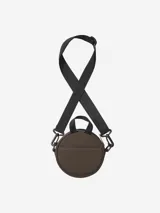 Cartera circular de Carhartt en color negro, confeccionada en nylon. Presenta un diseño minimalista con el logo de la marca grabado en relieve en el frente, cierre superior y correa ajustable extraíble.