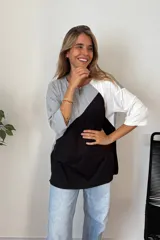 Remerón de manga tres cuartos con diseño de bloques de color en diagonal: gris claro en la parte superior izquierda, negro en la parte inferior derecha y blanco en la manga derecha. Posee cuello redondo y calce holgado.