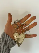 Collar plateado con cadena de eslabones grandes y dije de corazón.