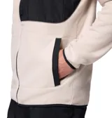 Campera de polar Columbia modelo Fast Trek Overlay, de color beige con detalles en negro. Presenta cierre frontal completo, cuello alto, bolsillo con cierre en el pecho y bolsillos laterales. Incluye ribetes elásticos en cuello, puños y dobladillo.