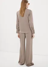 Pantalón de corte ancho, color tostado con sutiles rayas verticales en tonos marrones y oscuros, confeccionado en poliéster.