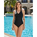 Malla entera de color verde oscuro, combinada con un diseño floreado en la parte inferior. Presenta escote halter cruzado y fruncidos en la zona del abdomen.