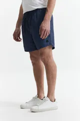 Short de baño celeste y azul con cintura elástica ajustable con cordón, dos bolsillos laterales y uno trasero. Confeccionado en tela ligera de secado rápido y logo bordado.