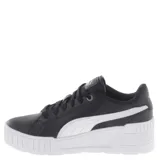 Championes Puma Karmen Wedge negros con plataforma blanca, detalles dorados y cordones negros.