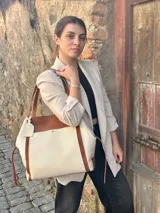 Bolso tote de cuero color natural con detalles en marrón.