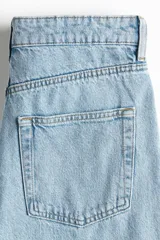 Jean tobillero de cinco bolsillos en denim de algodón rígido, con diseño curvo y volumen en las piernas de tiro alto.