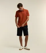Remera polo de corte comfort, confeccionada en algodón peruano de alta calidad. Presenta cuello clásico con tapeta de botones y mangas cortas. Diseño liso y texturizado, ideal para un look casual y fresco.