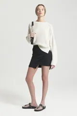 Minifalda negra de viscosa, ajustada al cuerpo, con corte irregular en el frente y cintura elástica.