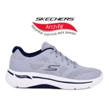 Championes deportivos Skechers Go Walk Arch Fit Guideline, color gris claro con detalles en azul marino y logo plateado. Cuentan con plantilla Arch Fit removible, amortiguación Ultra Go y tecnología Comfort Pillar.