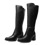 Bota bucanera de caña alta confeccionada en cuero negro con textura granulada. Presenta un diseño clásico con punta redonda, tacón cuadrado de altura media y cierre lateral interno.