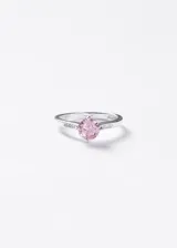 Anillo de plata 925 con una piedra central de zirconia rosa de corte redondo, engastada en cuatro puntas, y detalles de pequeñas zirconias en los laterales del aro.