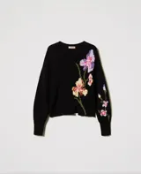 Sweater negro de algodón con cuello redondo, manga larga y corte holgado. Presenta incrustaciones florales decoradas con bordados a mano.