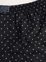 Bóxer de algodón blanco con estampado de flores pequeñas color celeste, con cintura elástica y logo de la marca en el centro.