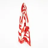 Pashmina de textura ligera con estampado abstracto en tonos rojo y crema, con bordes desflecados.