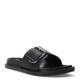 Sandalias Miss Carol Ciana de tipo slide, color negro, con una tira ancha en el empeine decorada con una hebilla metálica grande y texturizada. Presentan una suela plana y cómoda para uso diario.