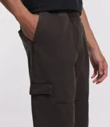 Pantalón cargo de hombre color negro, confeccionado en sarga de algodón, con cintura elástica, bolsillos laterales tipo cargo y bolsillos traseros.