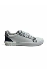 Championes deportivos color blanco con detalles estampados animal print tipo cebra en los laterales y talón, cordones anchos y suela de goma.