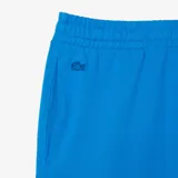 Pantalón de jogging azul con cintura elástica y cordón ajustable. Estampado lateral con logo de Lacoste y diseño de Netflix.