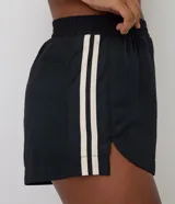 Bermuda deportiva Get Over para mujer, de color negro, con cintura elástica, rayas contrastantes en los laterales y bombacha interna.