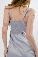 Vestido corto color borgoña, con breteles finos, escote recto y drapeado lateral con cordones ajustables.