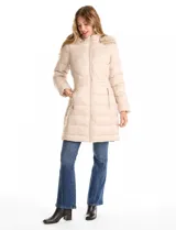 Campera puffer larga con diseño capitoneado, cierre frontal completo, bolsillos laterales con cierre y capucha desmontable con borde de piel sintética.