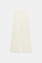 Pantalón palazzo de tiro medio en color marrón, confeccionado en tejido con textura. Cuenta con cintura elástica ajustable mediante cordones y diseño de pierna ancha.
