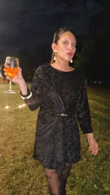 Vestido corto negro de terciopelo con estampado abstracto, mangas largas, espalda abierta en forma de gota y elástico en la cintura.