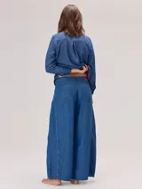 Pantalon de jean ancho, de corte holgado y fluido desde la cadera hasta el tobillo, con costuras verticales decorativas en el frente.