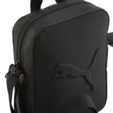 Bandolera Puma Buzz de color negro, diseñada con un compartimento principal con cierre, asa de mano superior y correa ajustable para el hombro. Presenta el logotipo de la marca en relieve en la parte frontal.