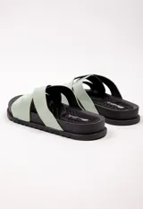 Sandalias bajas color verde agua, con dos tiras anchas cruzadas en el empeine y plataforma baja color negro.