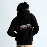 Hoodie negro de corte oversize con capucha y bolsillo frontal tipo canguro. Presenta un estampado gráfico en la espalda con el texto 'Nude Project Locally Hated' y una ilustración de cerezas.