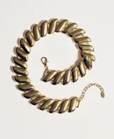 Collar de eslabones metálicos dorados con acabado brillante, de diseño plano y articulado, con cadena de alargue y cierre de mosquetón.