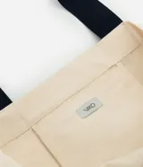 Bolsa de tela color beige con estampado de sirena en azul marino y asas reforzadas del mismo color.