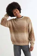 Sweater de tejido de punto con diseño degradé en tonos azules y beige, de corte holgado, cuello redondo y mangas largas.