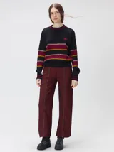 Sweater de punto cable con diseño a rayas horizontales en tonos marrón, amarillo y lila. Presenta cuello redondo acanalado, mangas largas con puños a juego y logo bordado en el pecho.