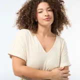 Camiseta de tejido crepé color beige, con escote en V y mangas cortas con dobladillo.