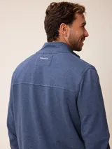 Buzo de cuello alto con cierre frontal completo, confeccionado en tejido de algodón y poliéster. Presenta un diseño liso en color azul melange con un pequeño logo bordado en el pecho y bolsillos laterales.