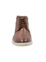 Botín de cuero color marrón con ajuste de cordones, cuello acolchado y suela de goma en color beige. Presenta el logo de la marca RKF grabado en el lateral.