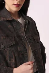 Campera de jean con estampado animal print en tonos marrones y negros, corte cropped y bolsillos delanteros.