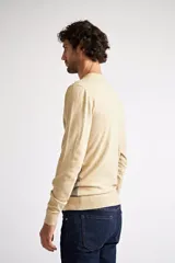 Sweater de punto con diseño color block, combinando azul marino en la parte superior, un patrón geométrico en tonos bordó y azul en el centro, y color camel en la parte inferior. Presenta cuello redondo y mangas largas.