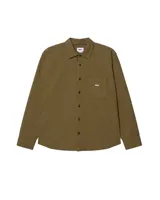 Camisa de manga larga Obey modelo Jimmy Woven, con estampado a cuadros en tonos marrón y negro. Tiene cuello clásico, cierre con botones y bolsillo en el pecho con logo bordado.