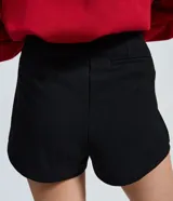 Short de sastre negro de tiro medio, confeccionado en crepé con caída estructurada y diseño evasé.