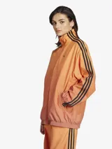 Campera deportiva Adidas Originals Firebird, color naranja con degradado, corte holgado, cierre frontal completo, cuello y puños acanalados, y las tres líneas negras características de la marca en las mangas.