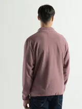 Campera de polar con cuello alto, cierre frontal completo y bolsillos laterales con cierre.