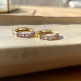 Aros tipo argolla de plata 925 con acabado en oro de 18k y circonitas violetas.