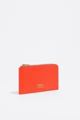 Tarjetero monedero color naranja con textura y logo metálico dorado de Bimba y Lola.