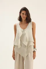 Musculosa de lino en color beige, con diseño de capas superpuestas que crean un efecto de volados en el frente.