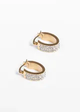 Aros tipo argolla ovalados de acero quirúrgico hipoalergénico, con strass.