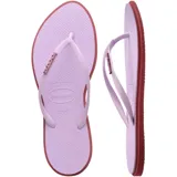 Ojotas Havaianas modelo Slim Point, con base color violeta claro y borde lateral en tono rojizo. Presentan tiras finas con textura y logo de la marca en relieve.