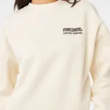 Buzo de cuello redondo Rip Curl, color beige, con estampado pequeño en el pecho y puños acanalados.